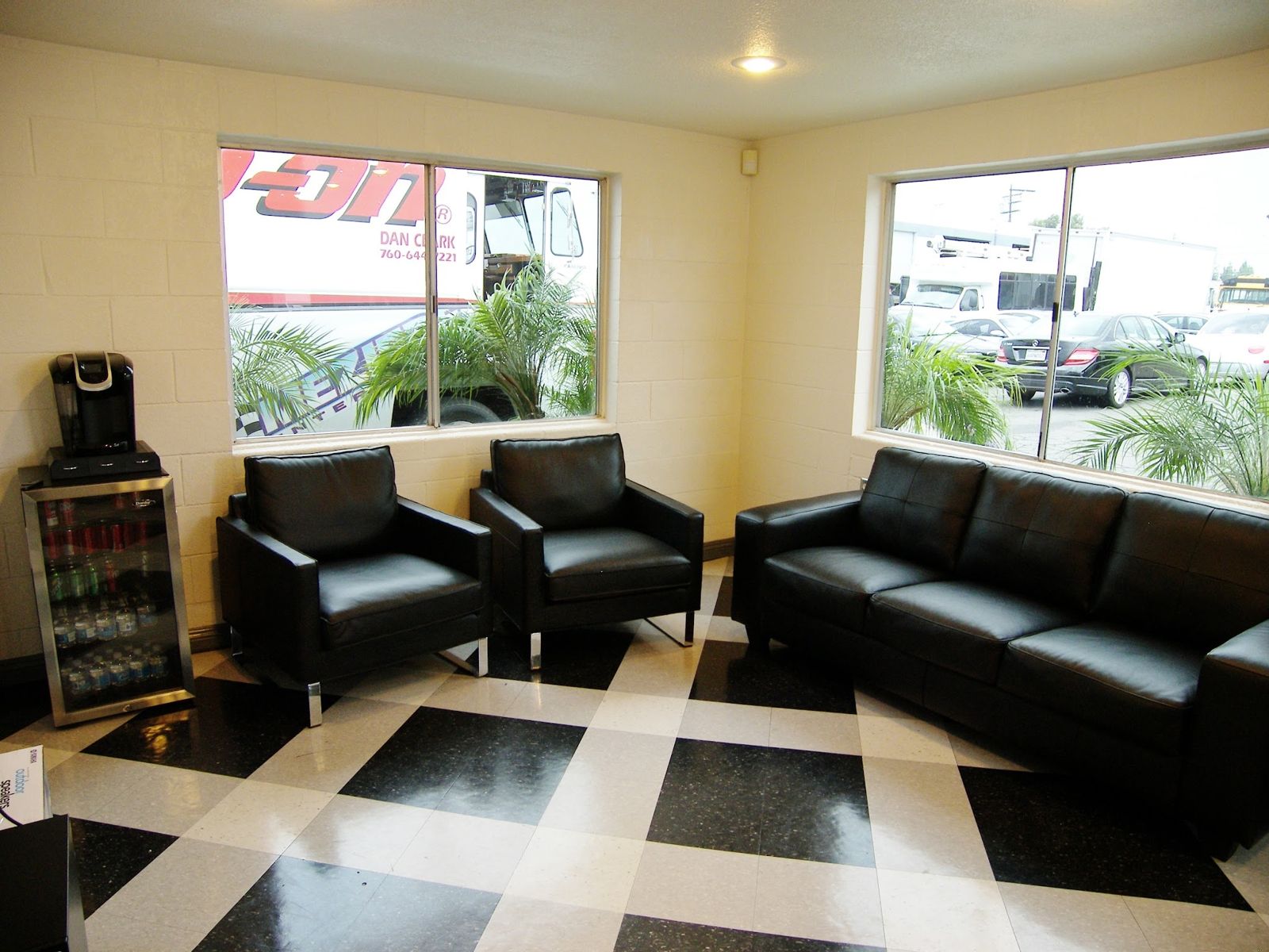 Second view of the customer lounge with leather seating and a coffee station